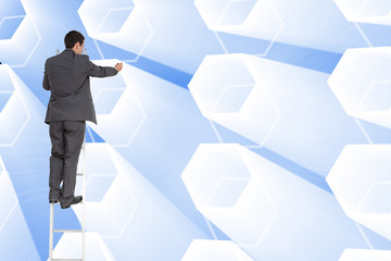 Composite image of businessman standing on ladder