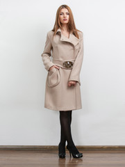 Sexy young woman wearing beige vintage coat with big collar