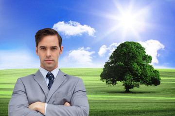 Composite image of young businessman looking at camera