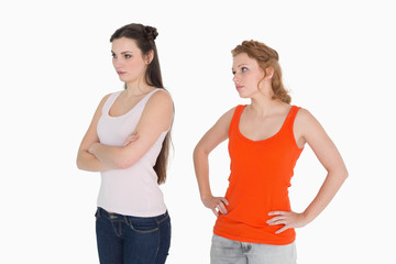 Unhappy young female friends not talking after argument