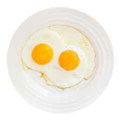 breakfast with two fried eggs in white plate