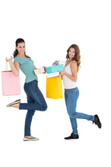 Two happy young female friends with shopping bags