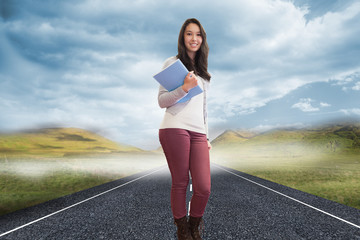 Composite image of smiling student in a computer room