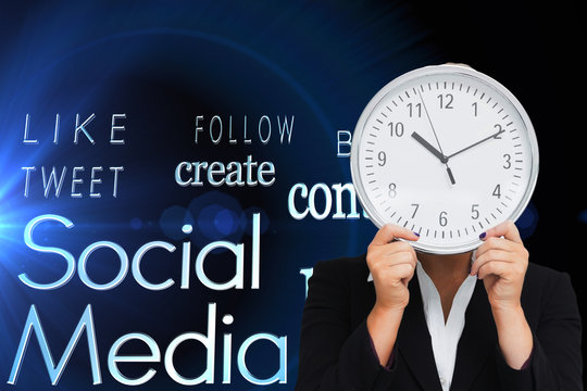 Composite image of businesswoman in suit holding a clock