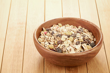 Plate with raw oatmeal on wooden table.