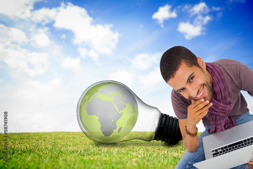 Aufkleber Composite image of thoughtful man sitting on floor using laptop