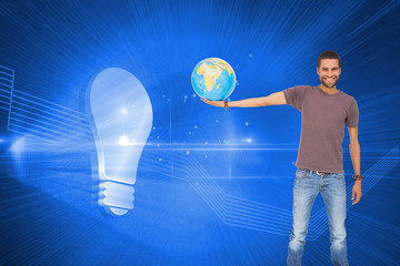 Composite image of handsome man holding out a globe