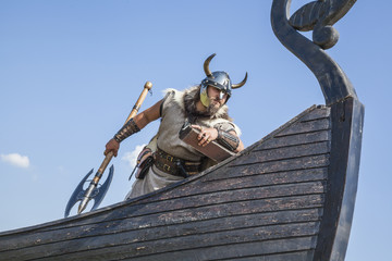 Strong Viking on his ship looking to beach