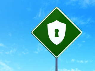 Privacy concept: Shield With Keyhole on road sign background