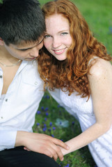 Obraz premium beautiful young couple in love on a green glade