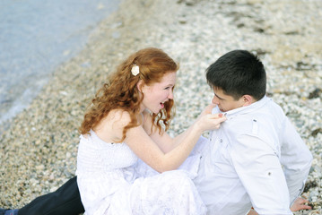 beautiful young couple in love near the sea