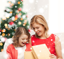 happy mother and child girl with gift box