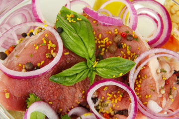 A large piece of pork marinated in bowl close-up isolated