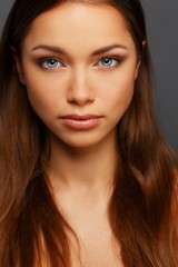 Beautiful young brunette woman with blue eyes