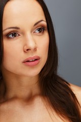 Obraz premium Beautiful young brunette woman with brown eyes and long hair