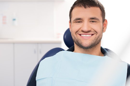 Smiling young man at dentist's surgery