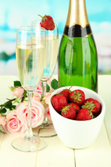 Romantic still life with champagne, strawberry and pink roses,