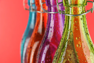 Colorful bottles on red background