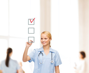 doctor or nurse drawing checkmark into checkbox
