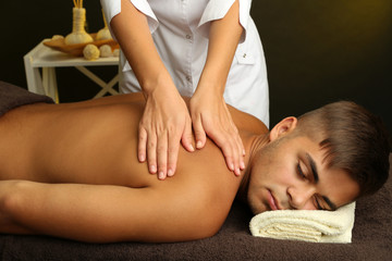 Obraz na płótnie Canvas Young man having back massage close up