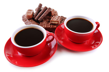 Red cups of strong coffee and chocolate bars close up