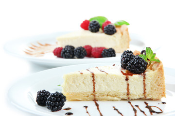 Slices of cheesecakes on plate, close-up