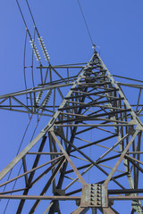high voltage transmission pylon on blue sky background