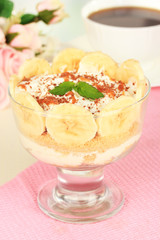 Delicious dessert with banana and caramel on table close-up