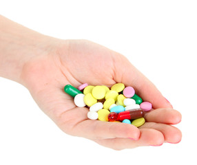 Pills in hand isolated on white