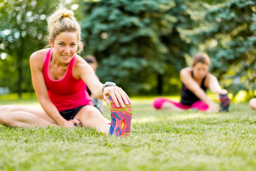 young woman stetching before a jog