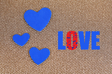 Blue hearts made of felt on golden background