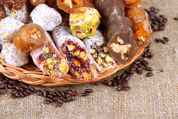 Tasty oriental sweets, on burlap background