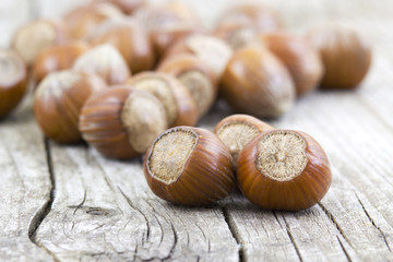 hazelnuts on old wooden background