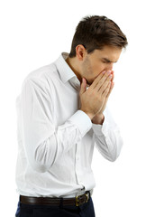 Sneezing young man isolated on white