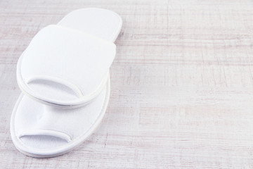 White slippers on wooden background