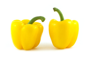 Two big yellow ripe bell peppers isolated on white closeup