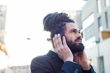 Stylish elegant dreadlocks businessman headphones