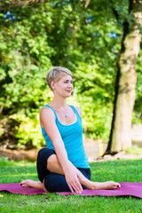 Young woman in nature doing yoga