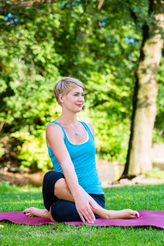 Young woman in nature doing yoga
