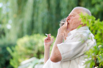 Senior man and woman smoking