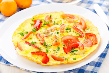 Omelet with paprika, tomato and herbs