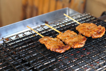 Roasted porks sticks grill on electrical roaster.