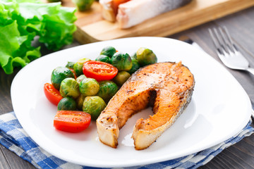 Salmon with roasted brussels sprout and tomato