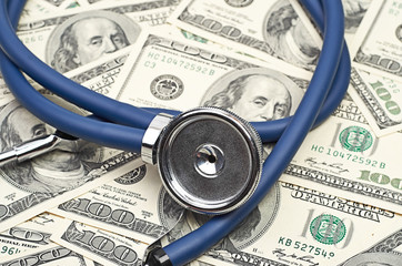heap of dollars with stethoscope