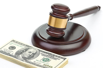 Obraz na płótnie Canvas Law gavel on a stack of American money.