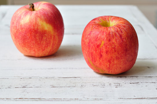 Red Apples On White Wood Table.