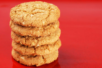 Fototapeta na wymiar Stack of peanut butter cookies on red