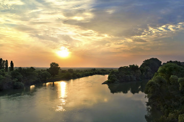 Summer dawn on the river wooded