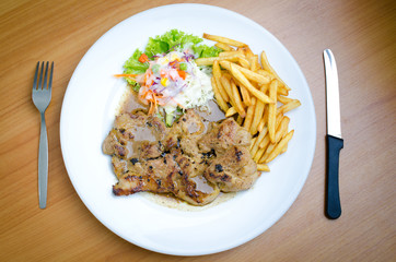 Grilled steak, French fries and vegetables