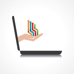 hand holding colorful arrows comes from laptop screen